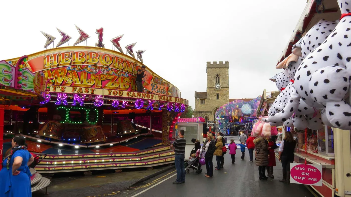 The Michaelmas Fair on Ock Street, with the tower of St Helen's Church behind